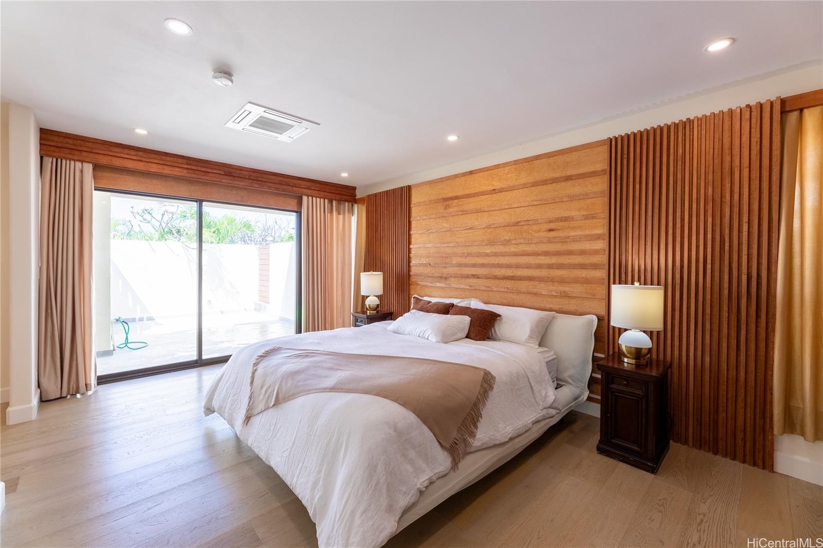 1632 Ihiloa Loop Honolulu, HI 96821 - Photo 14 of 24 a bedroom with a large bed and a large window