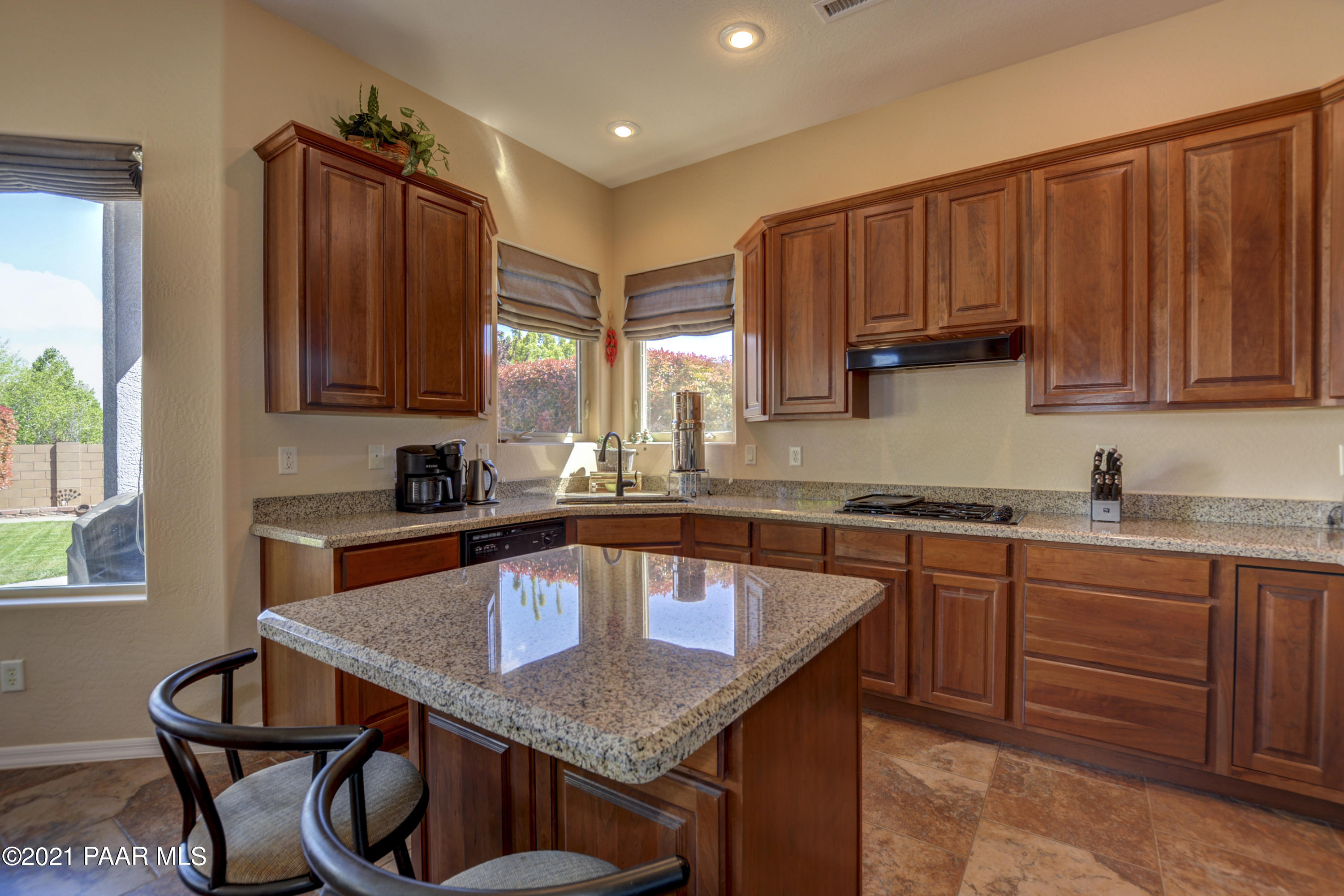 6582 Farmstead Road, Unit 3 Prescott Valley, AZ 86314 - Photo 11 of 41 a kitchen with granite countertop a sink a stove cabinets and dining table
