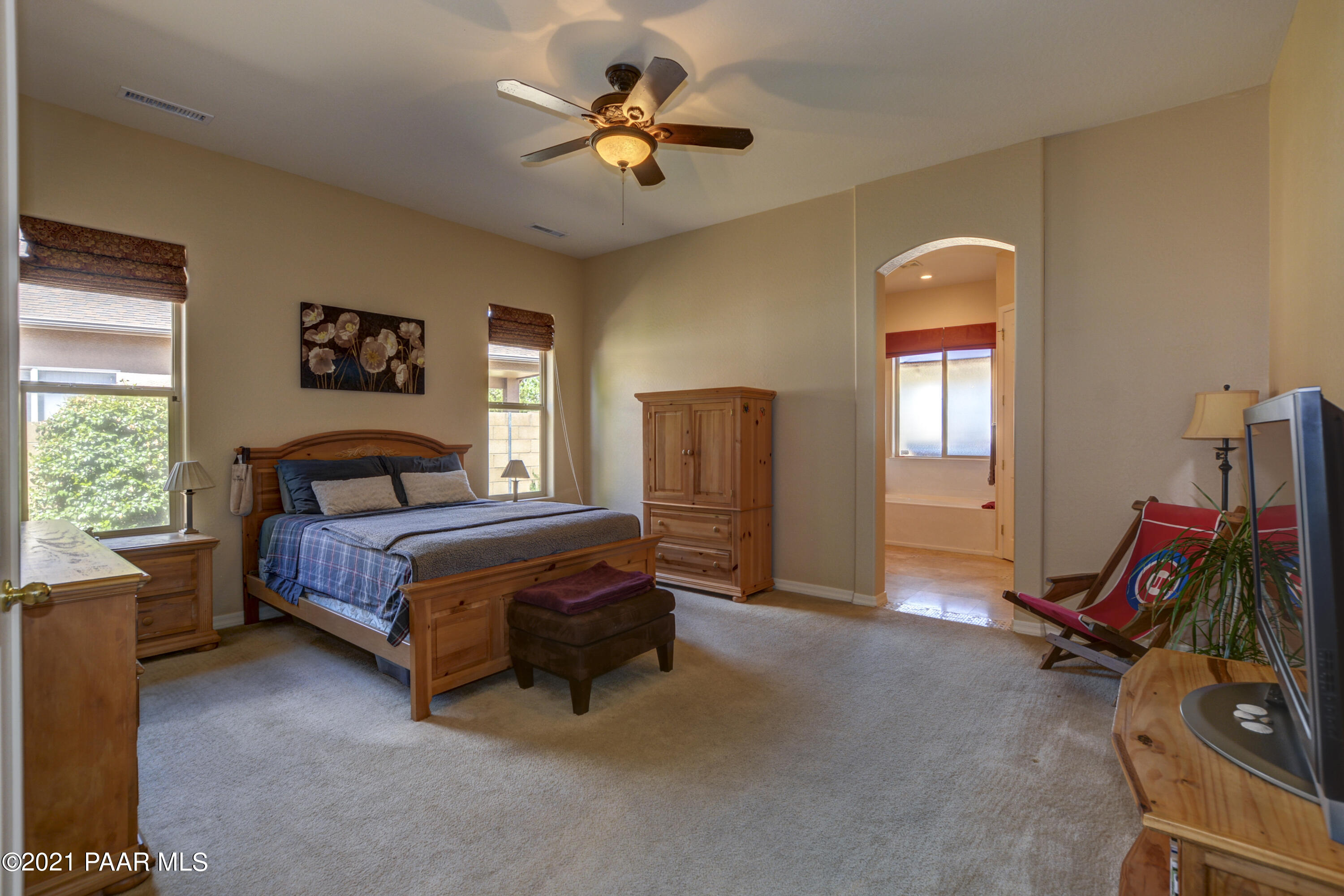 6582 Farmstead Road, Unit 3 Prescott Valley, AZ 86314 - Photo 13 of 41 a bedroom with bed and a chandelier
