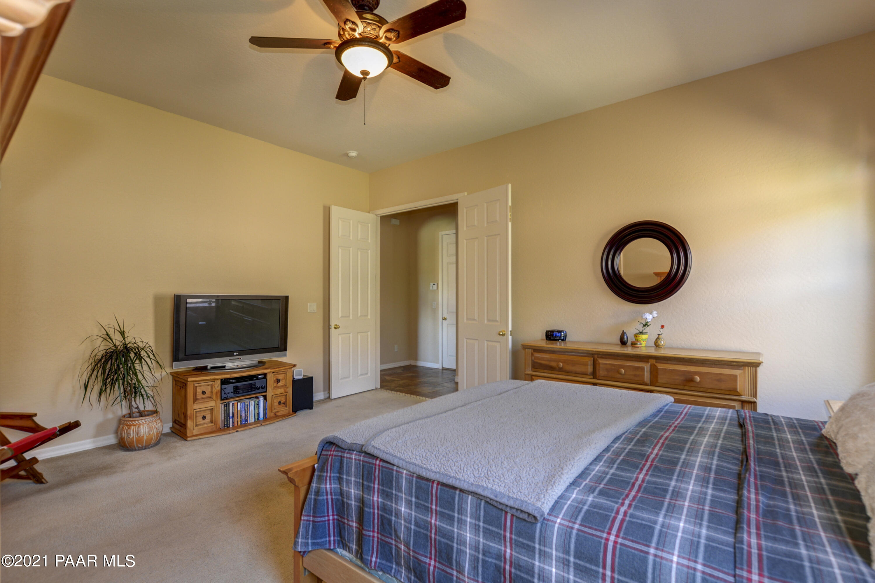6582 Farmstead Road, Unit 3 Prescott Valley, AZ 86314 - Photo 14 of 41 a bedroom with a bed and a flat tv screen on dresser