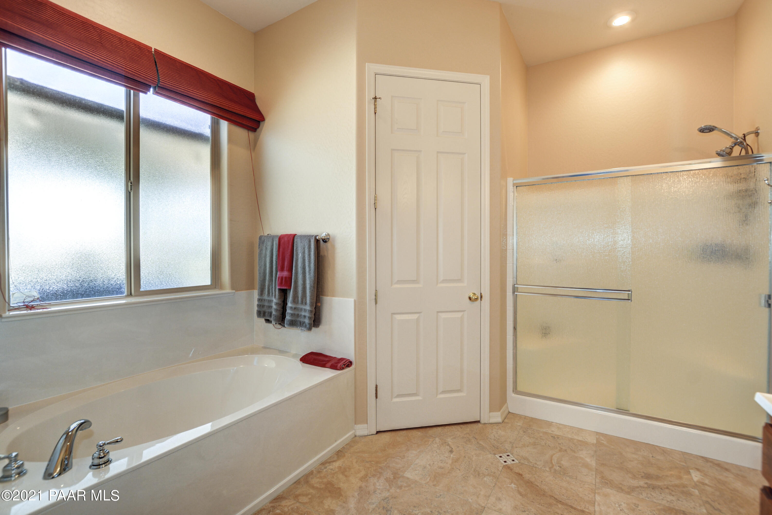 6582 Farmstead Road, Unit 3 Prescott Valley, AZ 86314 - Photo 16 of 41 a bathroom with a tub and a shower