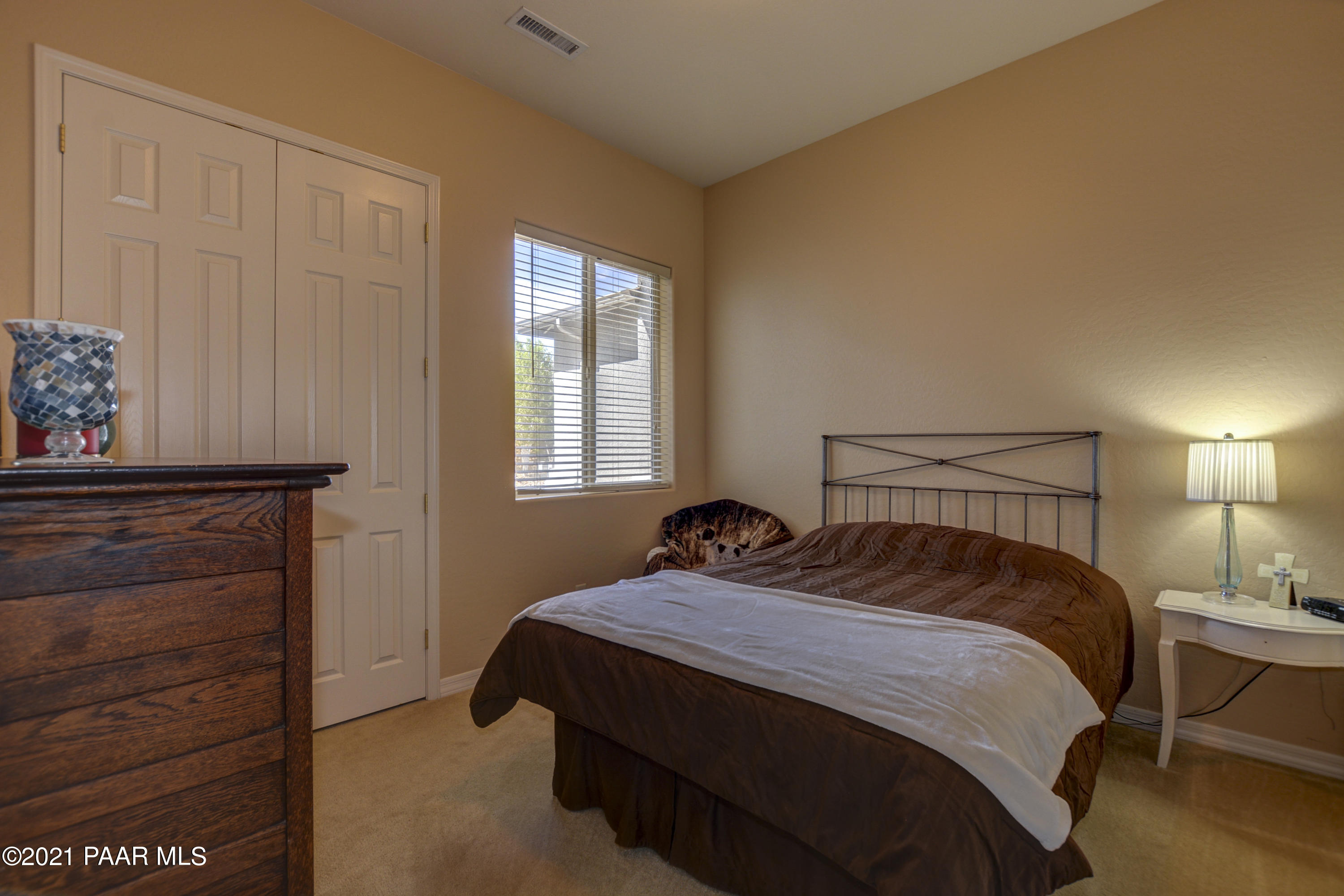 6582 Farmstead Road, Unit 3 Prescott Valley, AZ 86314 - Photo 18 of 41 a bedroom with a bed and a window
