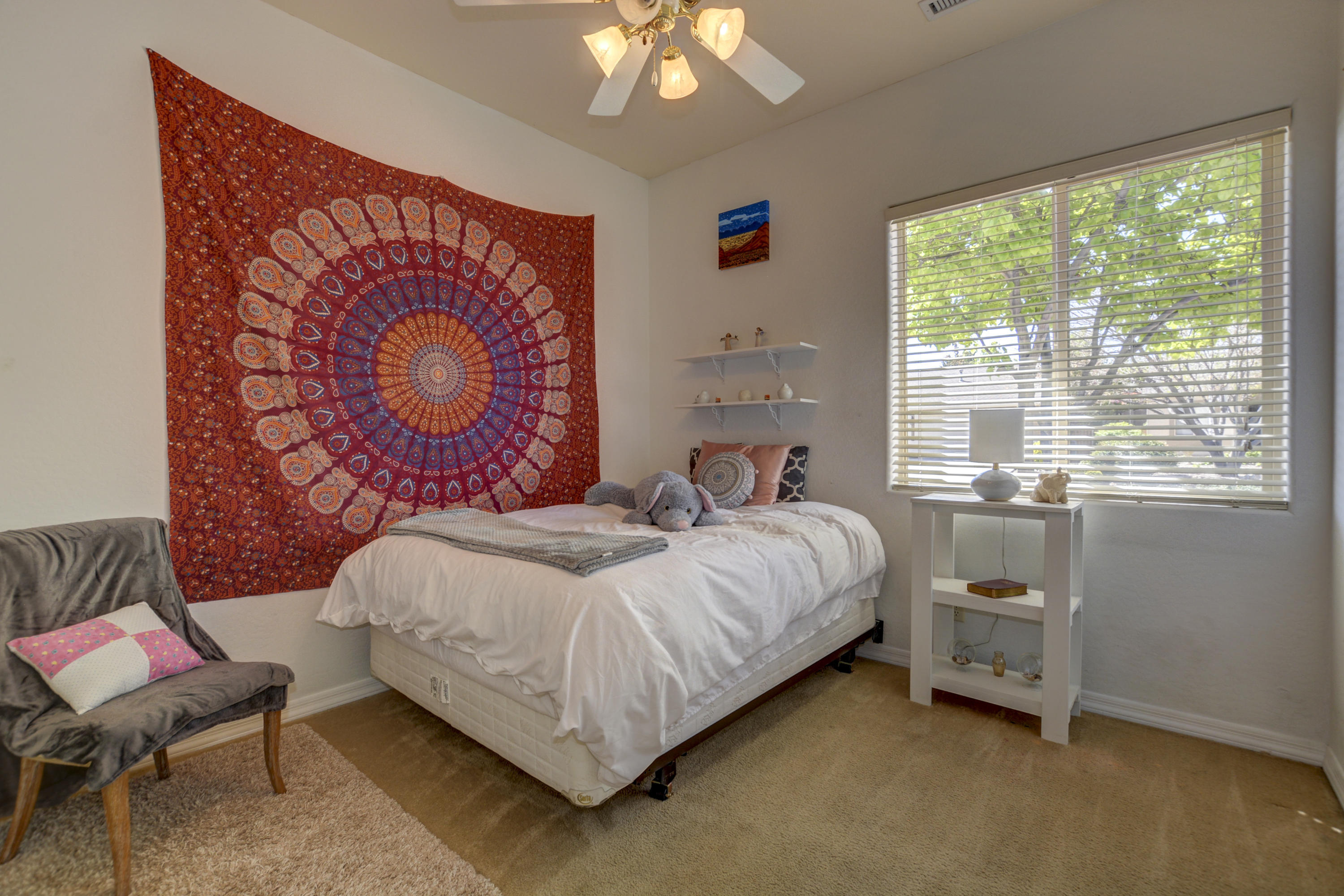 6582 Farmstead Road, Unit 3 Prescott Valley, AZ 86314 - Photo 19 of 41 a bedroom with a bed and a chair