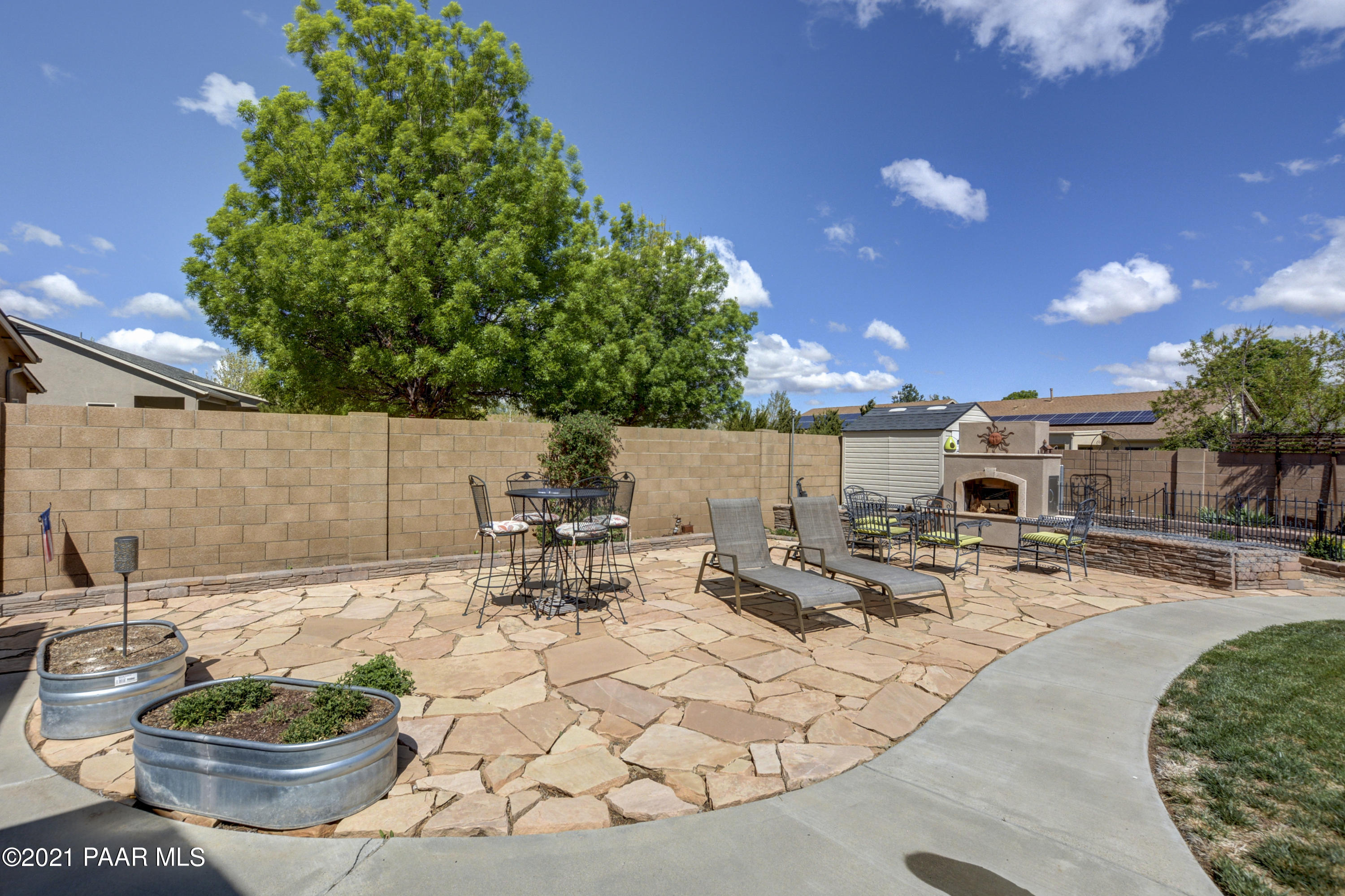 6582 Farmstead Road, Unit 3 Prescott Valley, AZ 86314 - Photo 30 of 41 a view of a backyard with sitting area