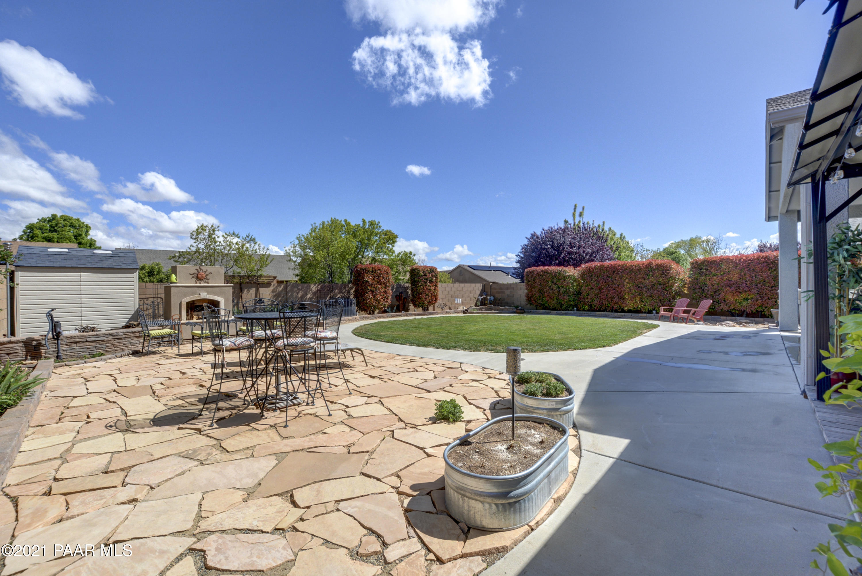 6582 Farmstead Road, Unit 3 Prescott Valley, AZ 86314 - Photo 32 of 41 a view of a backyard with furniture and a fire pit
