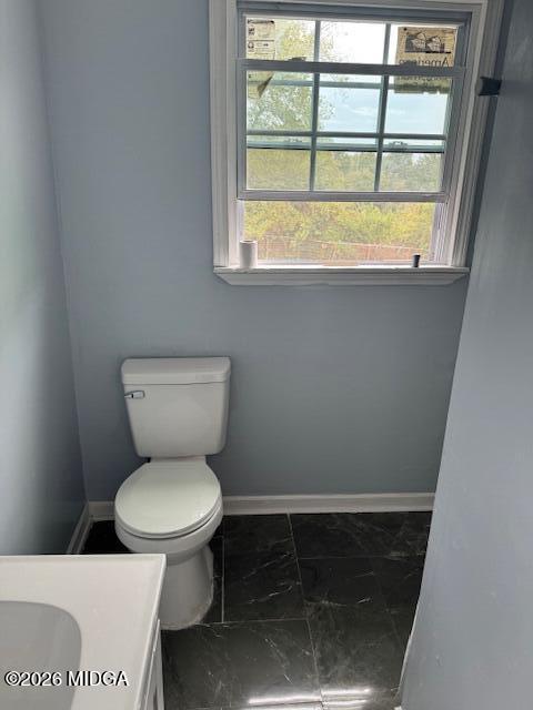2175 Winship Street Macon, GA 31204 - Photo 13 of 15 a bathroom with a toilet and a window