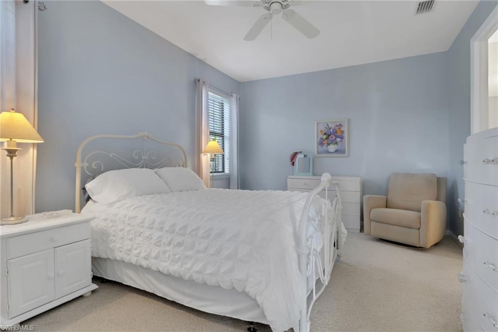 26233 Palace Lane, Unit 201 Bonita Springs, FL 34135 - Photo 13 of 46 a bed room with a bed and a couch