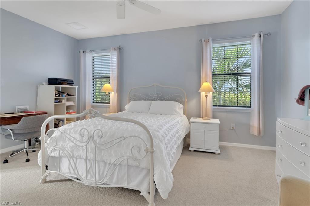 26233 Palace Lane, Unit 201 Bonita Springs, FL 34135 - Photo 14 of 46 a spacious bedroom with a bed and a window