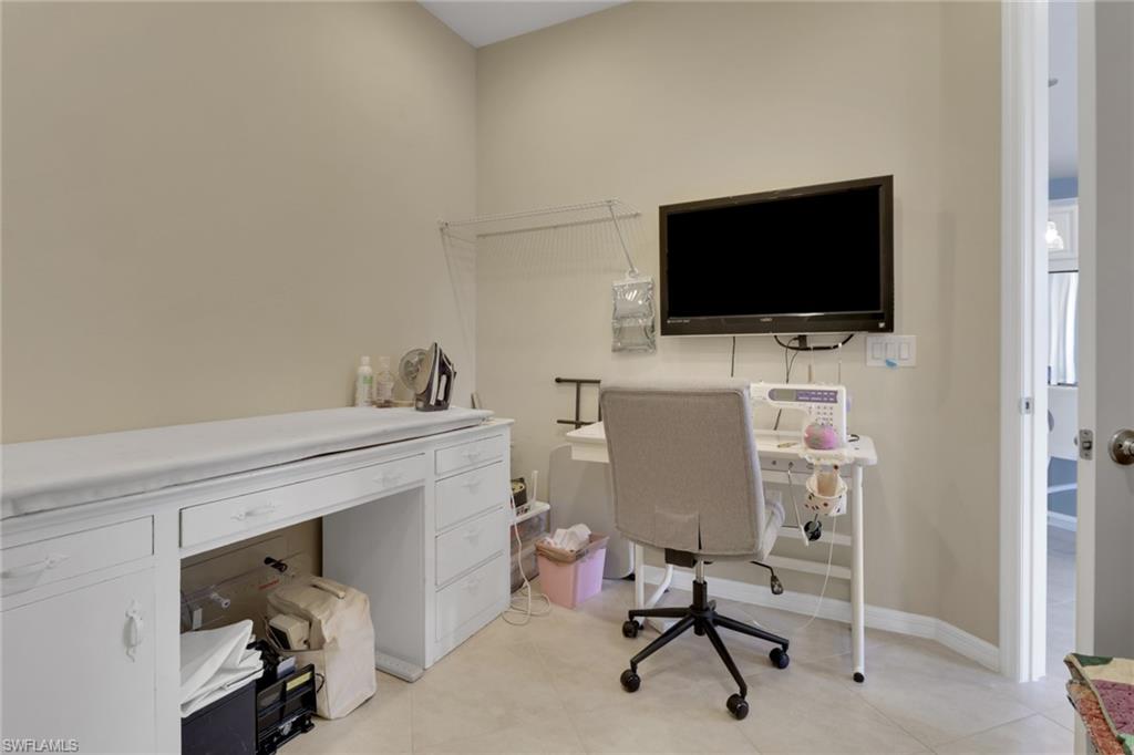 26233 Palace Lane, Unit 201 Bonita Springs, FL 34135 - Photo 18 of 46 a view of a livingroom with furniture and a flat screen tv