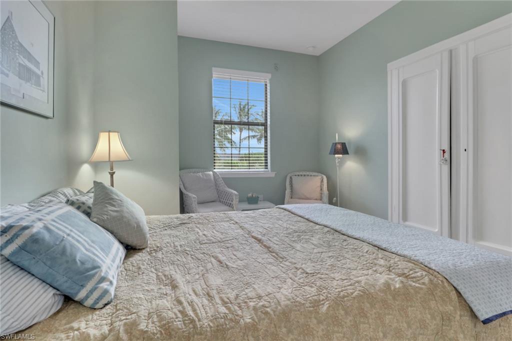 26233 Palace Lane, Unit 201 Bonita Springs, FL 34135 - Photo 23 of 46 a bedroom with a bed and a window