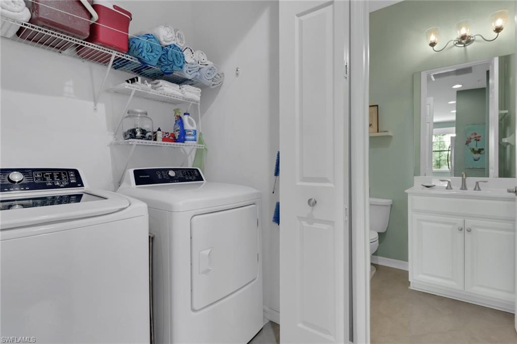 26233 Palace Lane, Unit 201 Bonita Springs, FL 34135 - Photo 24 of 46 a utility room with dryer and washer