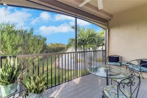 a balcony with furniture and a potted plant