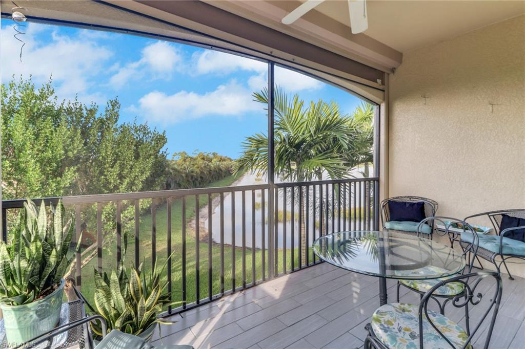 26233 Palace Lane, Unit 201 Bonita Springs, FL 34135 - Photo 25 of 46 a balcony with furniture and a potted plant