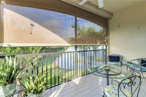 a balcony with table and chairs
