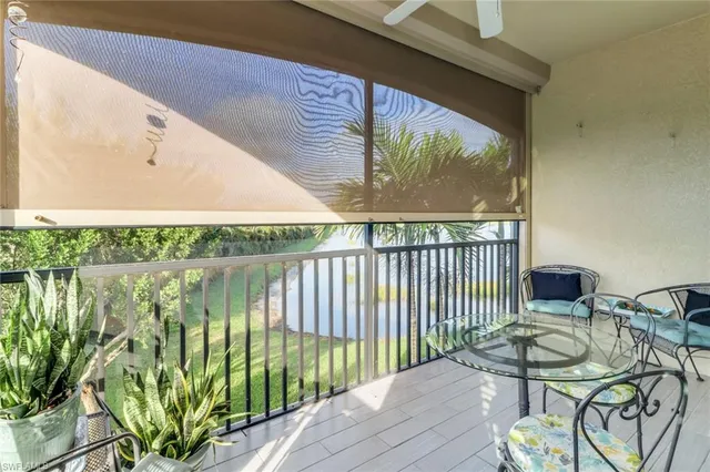 a balcony with table and chairs