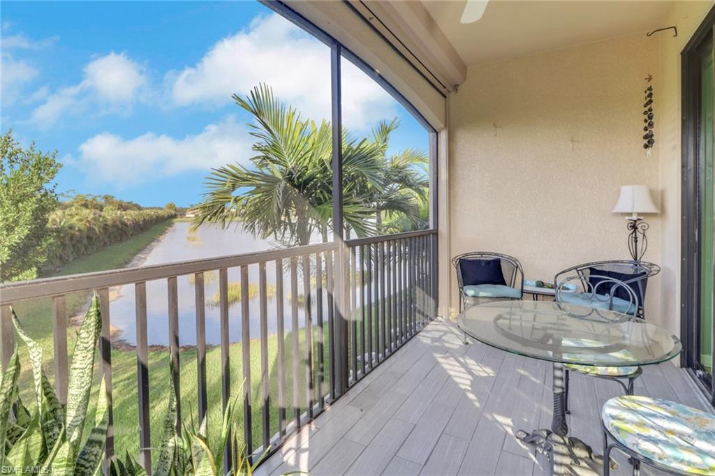 26233 Palace Lane, Unit 201 Bonita Springs, FL 34135 - Photo 27 of 46 a balcony with furniture and a potted plant