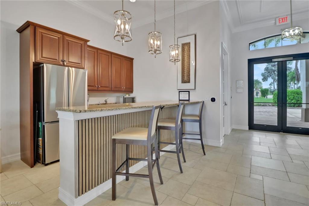 26233 Palace Lane, Unit 201 Bonita Springs, FL 34135 - Photo 30 of 46 a dining room with furniture and window