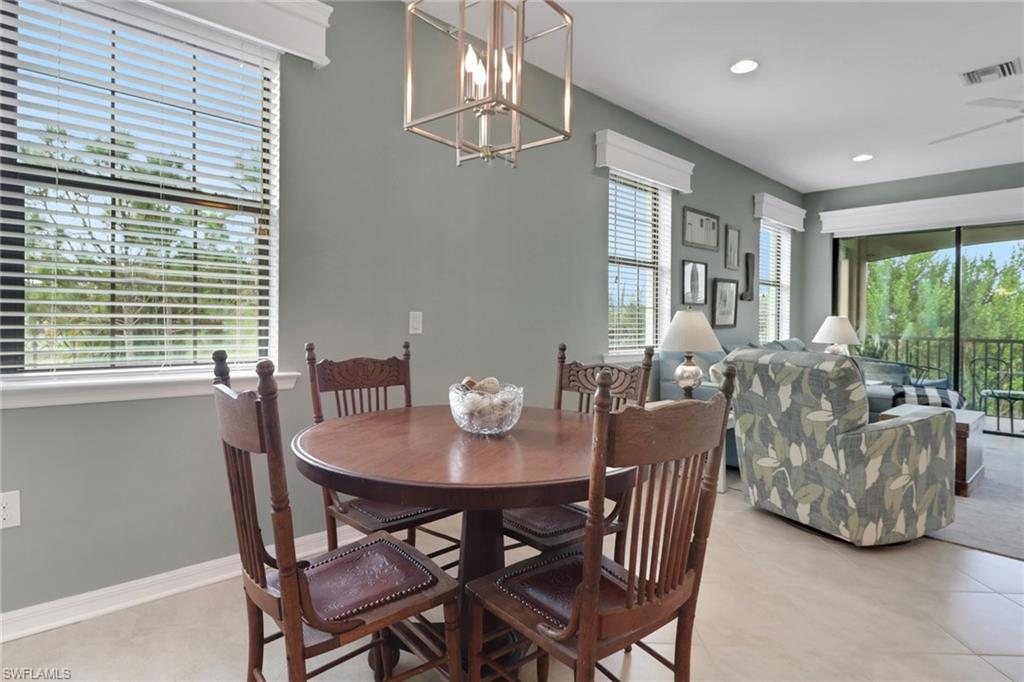 26233 Palace Lane, Unit 201 Bonita Springs, FL 34135 - Photo 3 of 46 a view of a dining room with furniture window and outside view
