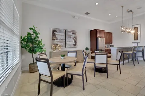 a view of a dining room with furniture and chandelier