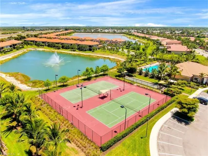 an aerial view of a tennis ground and a large pool