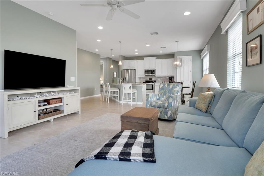 26233 Palace Lane, Unit 201 Bonita Springs, FL 34135 - Photo 10 of 46 a living room with furniture and a flat screen tv