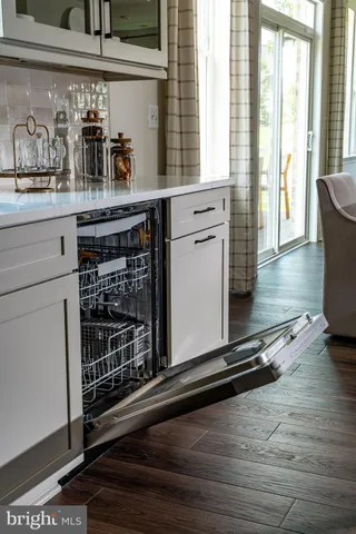 a kitchen with wooden floor and window