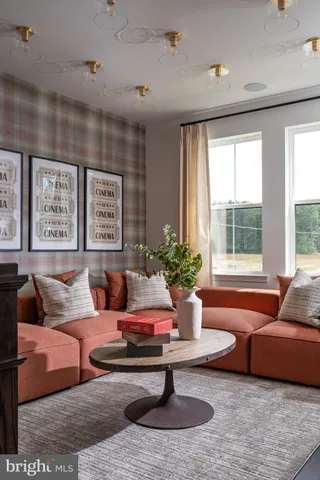a living room with furniture potted plant and a large window