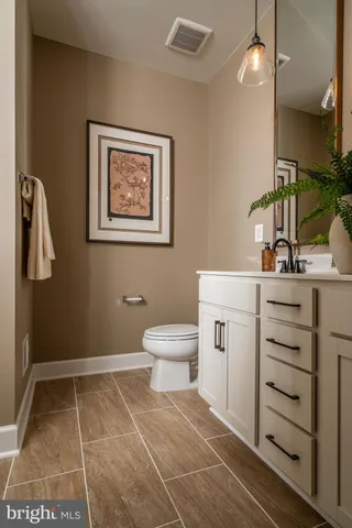 a bathroom with a toilet sink and mirror