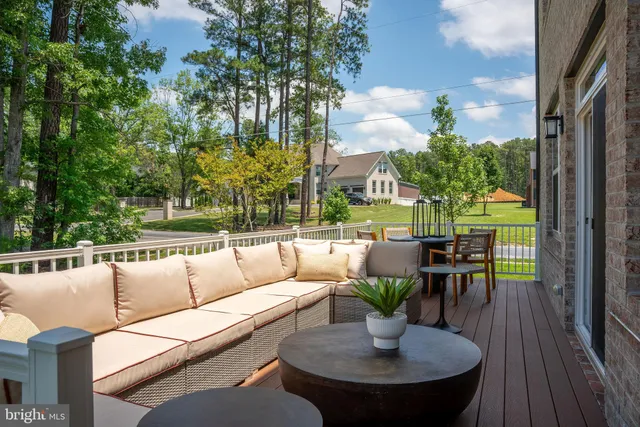 a view of a patio with couches potted plants and a dining table with garden view