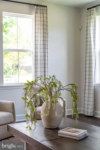 a vase of flowers sitting on a table with a window