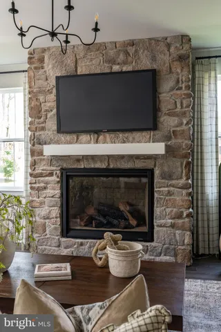 a living room with a fireplace and a fireplace