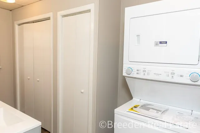 a view of a room with wooden floor and windows