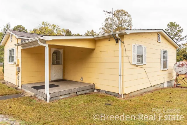 a view of a blue house with a large window
