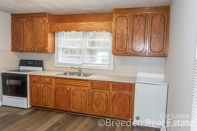 a kitchen with stainless steel appliances granite countertop a sink and a microwave