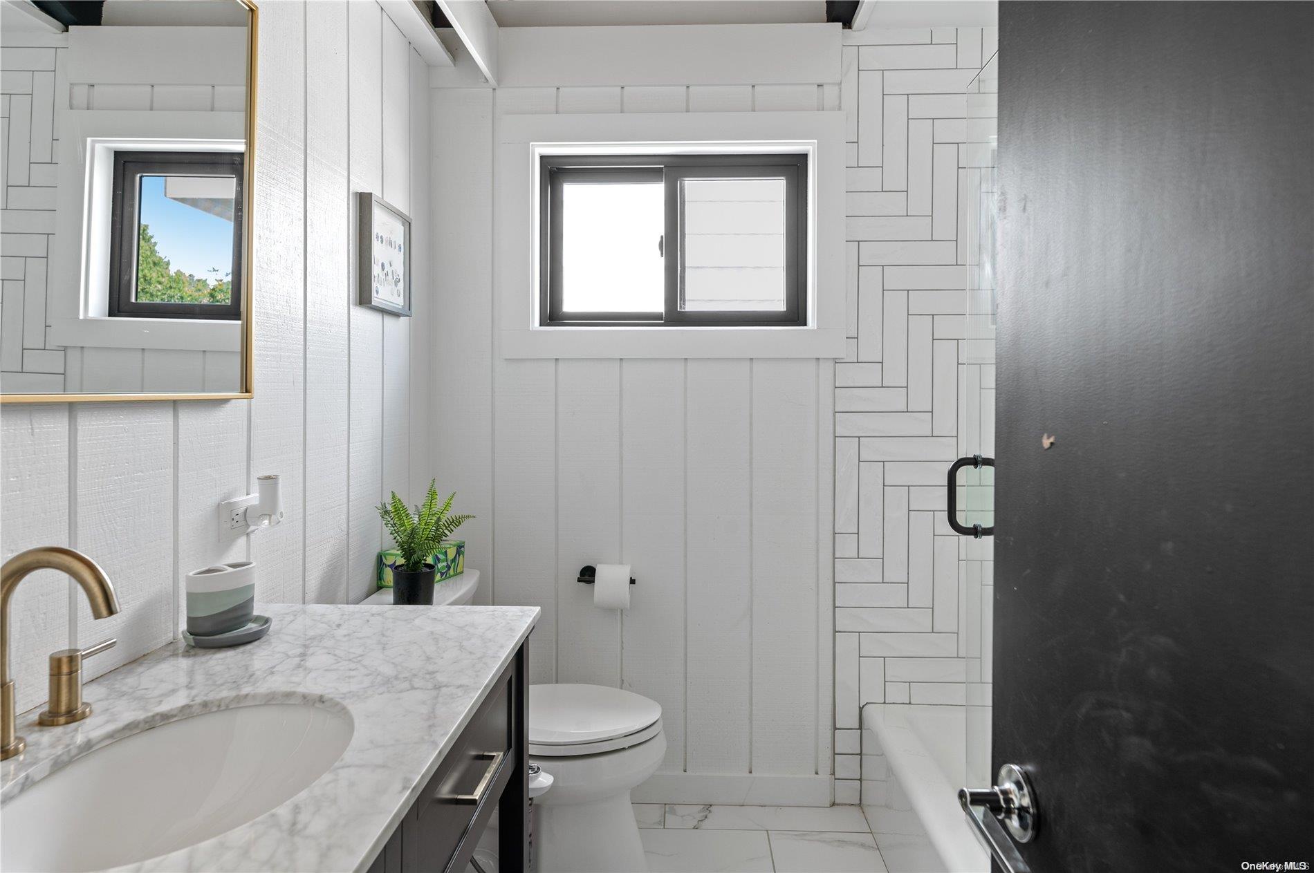 220 Cottage Walk Ocean Beach, NY 11770 - Photo 11 of 32 a bathroom with a granite countertop sink toilet and shower
