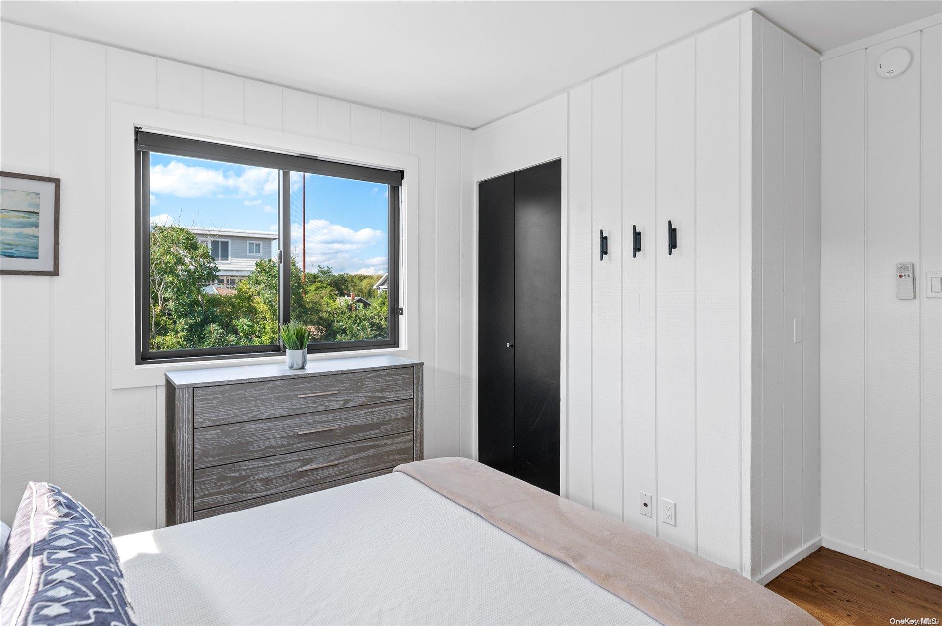 220 Cottage Walk Ocean Beach, NY 11770 - Photo 16 of 32 a bedroom with a bed and a large window