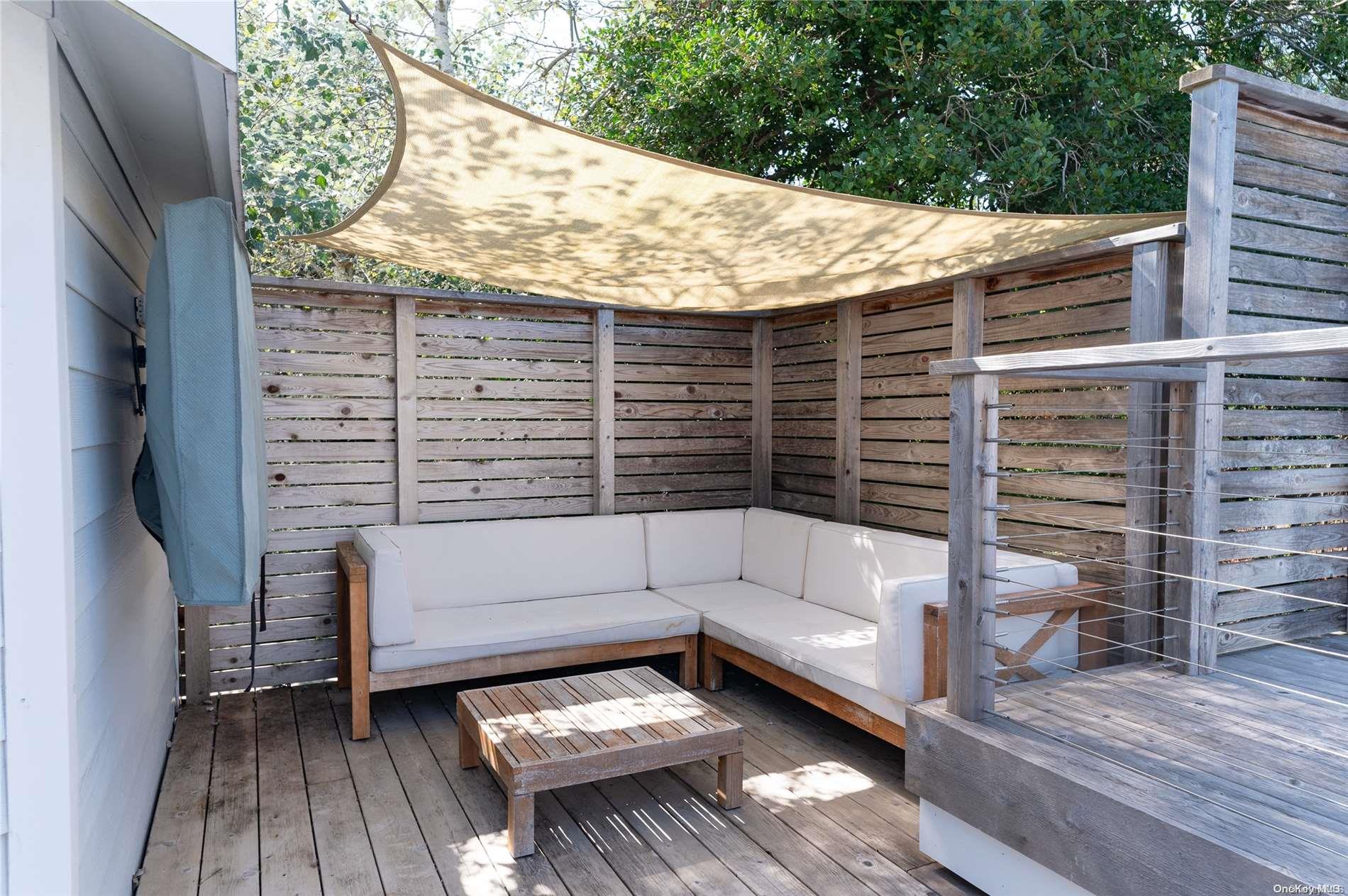 220 Cottage Walk Ocean Beach, NY 11770 - Photo 22 of 32 a backyard of a house with wooden floor and outdoor seating