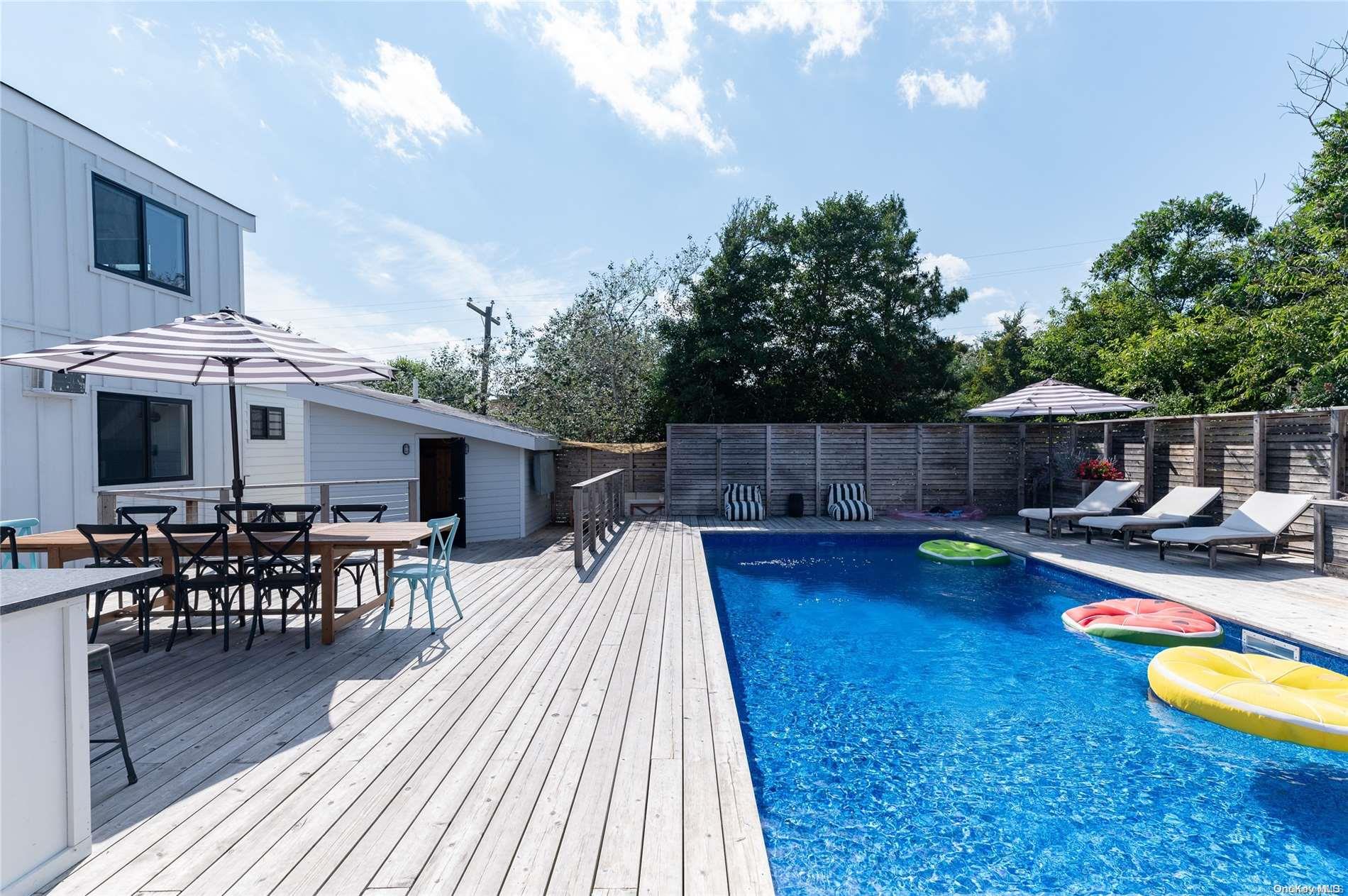 220 Cottage Walk Ocean Beach, NY 11770 - Photo 24 of 32 a swimming pool with outdoor seating and yard in the back