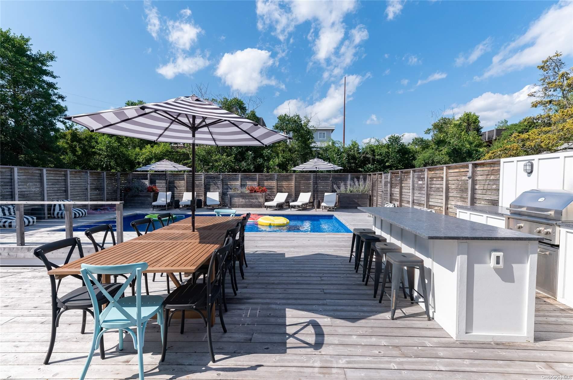 220 Cottage Walk Ocean Beach, NY 11770 - Photo 25 of 32 a view of a patio with a table and chairs