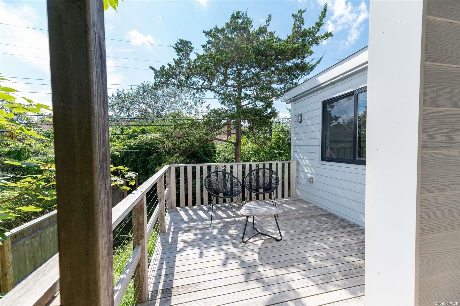 220 Cottage Walk Ocean Beach, NY 11770 - Photo 30 of 32 a view of balcony with wooden floor and outdoor seating