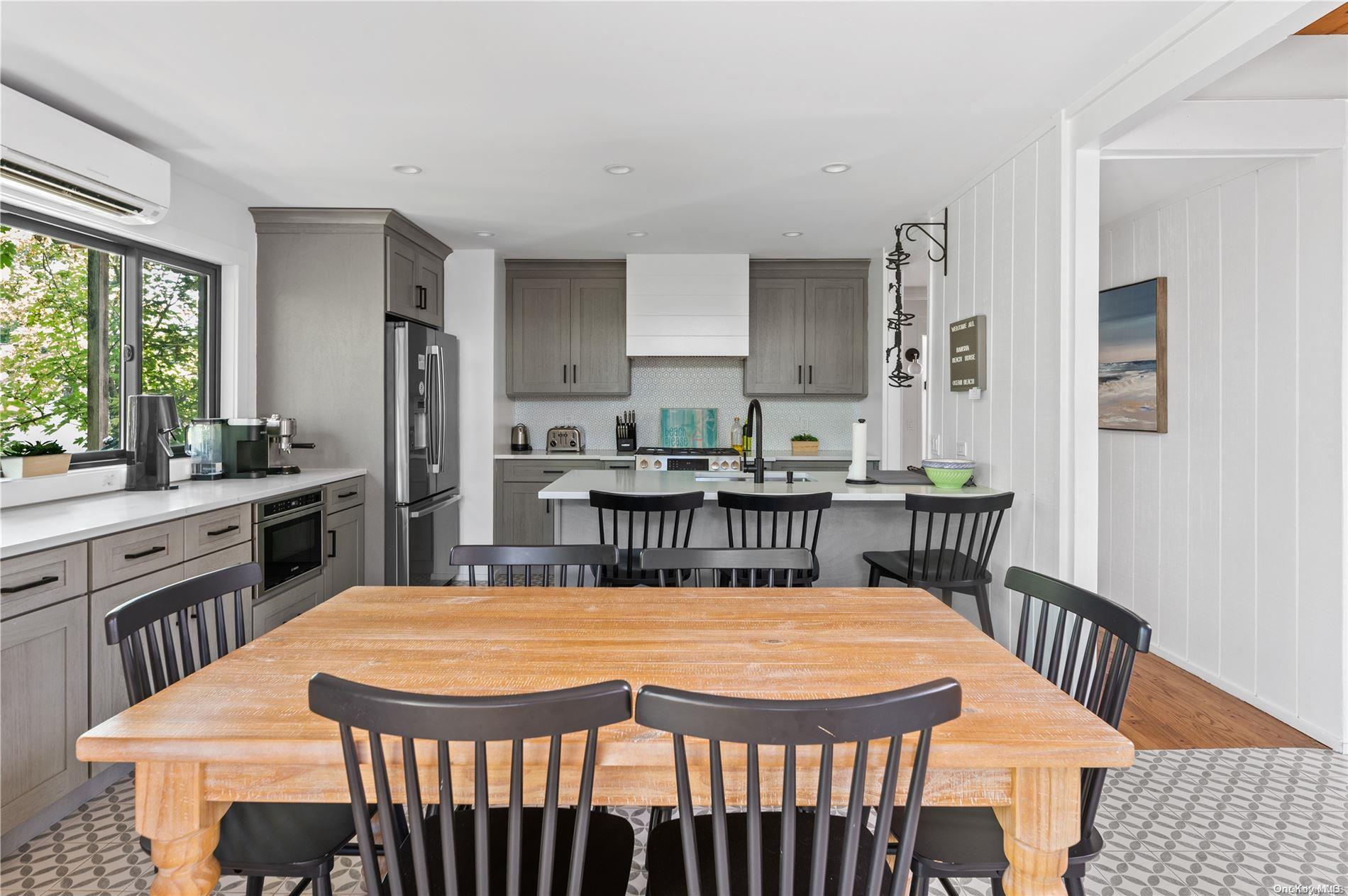 220 Cottage Walk Ocean Beach, NY 11770 - Photo 8 of 32 a dining room with a table chairs and entryway