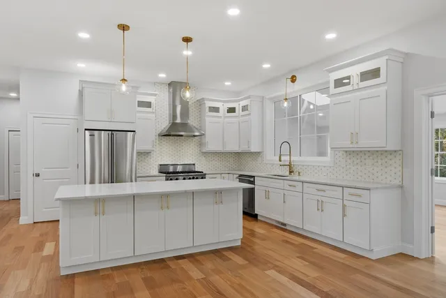 a large kitchen with stainless steel appliances lots of counter space sink and cabinets