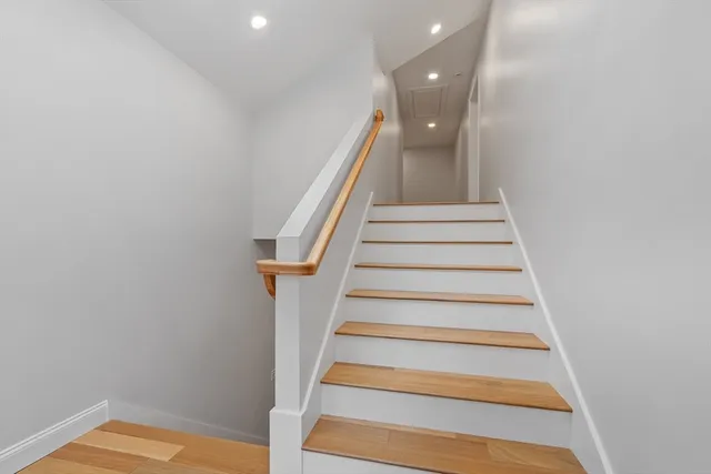a spacious bathroom with a tub sink shower and mirror