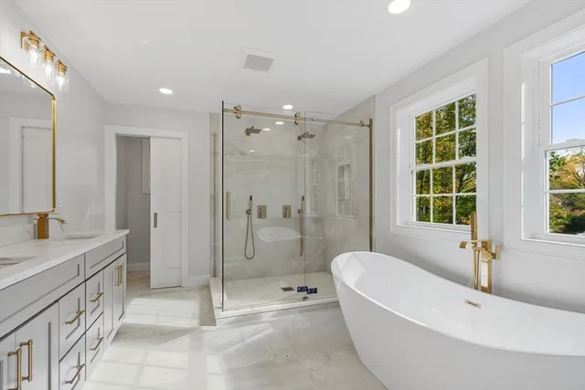 a bathroom with a double vanity sink mirror and shower
