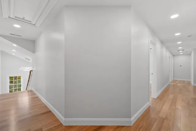 a spacious bathroom with a granite countertop sink a toilet and a mirror