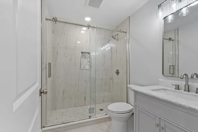 a bathroom with a toilet sink and mirror