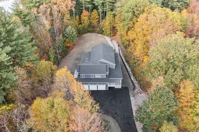 a front view of a house with a tree