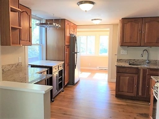 27 Appleton Street Salem, MA 01970 - Photo 22 of 31 a kitchen with stainless steel appliances granite countertop a refrigerator and a stove top oven
