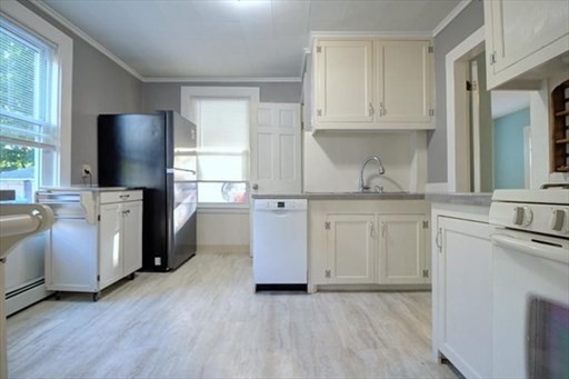 27 Appleton Street Salem, MA 01970 - Photo 25 of 31 a kitchen with stainless steel appliances granite countertop a stove a sink and a refrigerator