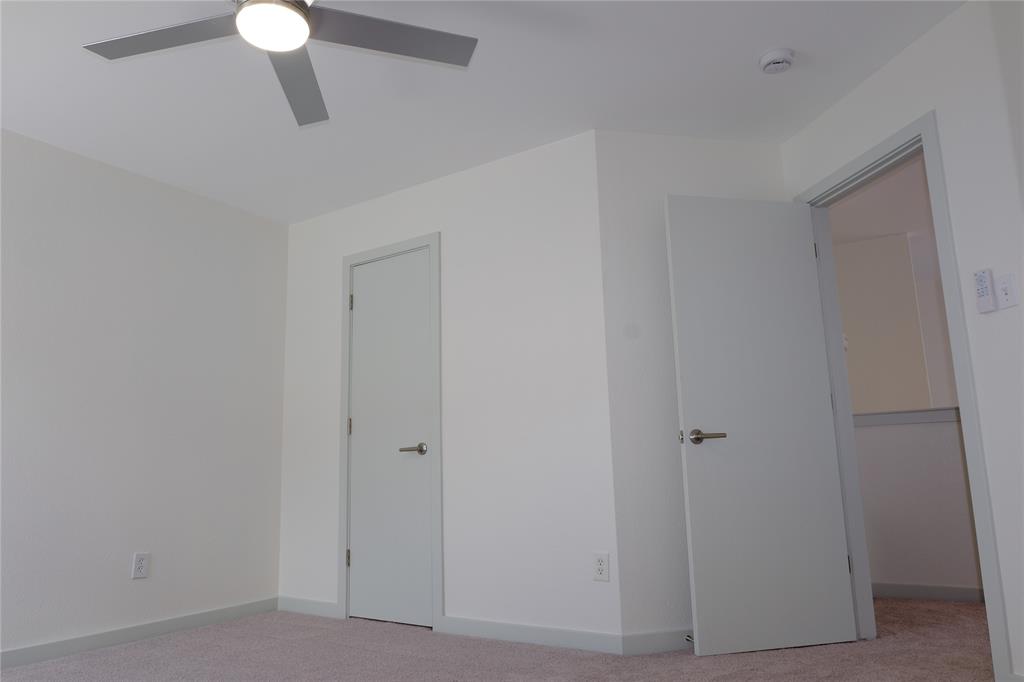 3437 Caprock Ranch Road Fort Worth, TX 76262 - Photo 14 of 27 a view of a hallway with a chandelier fan